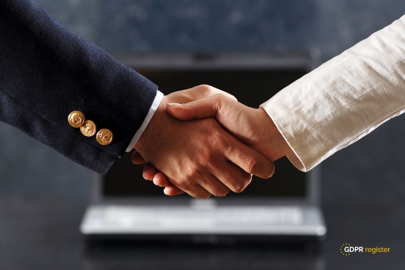 Business handshake in front of a laptop, symbolizing trust and compliance, relating to Google Recaptcha cookies and GDPR compliance concerns.